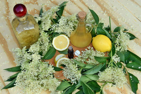 Health drink from elderberry flowers on a wooden table