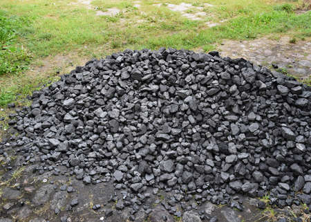 A heap of black natural coal, coal mine background, texture