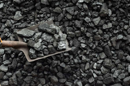 Shovel and coal in the background coal mine