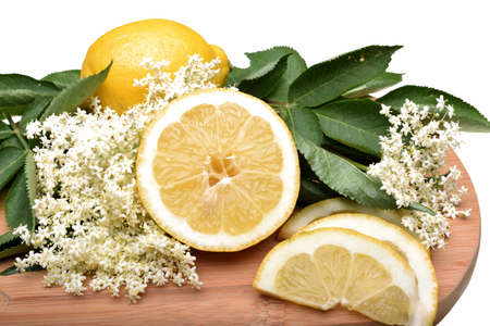 Elderflower with lemon on the wooden board isolated on white backgroundの写真素材