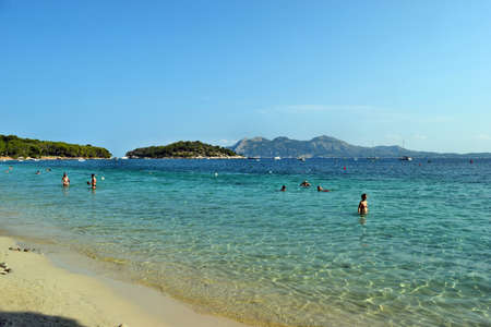 Platja de Formentor, Mallorca, Spain - September 01, 2018: Sea bay with turquoise water, beach and mountainsのeditorial素材