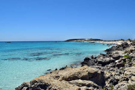 Elafonisi beach, Crete - June 18, 2021: View on the tropical beach with an amazing turquoise water and red / pink sandのeditorial素材