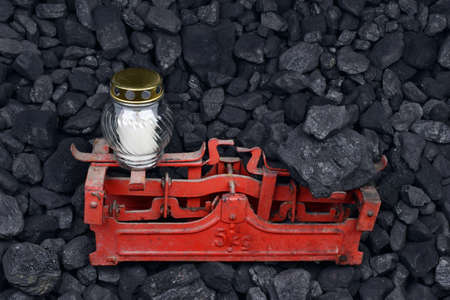 Graveyard candle and coal on the weight as concept after the fatal accident in the mineの写真素材