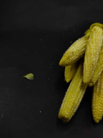 Abstract Defocused Photo of a pile of pickled baby corn, isolated on a black background in the Cikancung area - Indonesia. Not Focusの写真素材