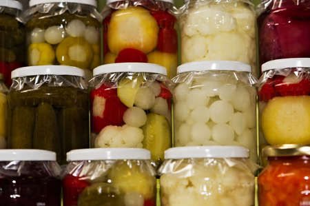 glass jars of colorful pickled vegetablesの写真素材