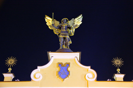 Beautiful sculpture against the background of the night sky in the form of a man with angel wings sword in one hand and a shield in the other.のeditorial素材