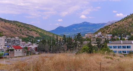 Residential resort town with large houses and small cottages against the backdrop of endless mountain rangesの写真素材