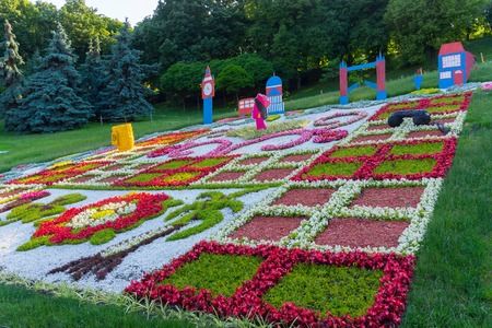 Figured flowerbed with pictures of cardboard symbolizing England. Contrast of green and colorの写真素材