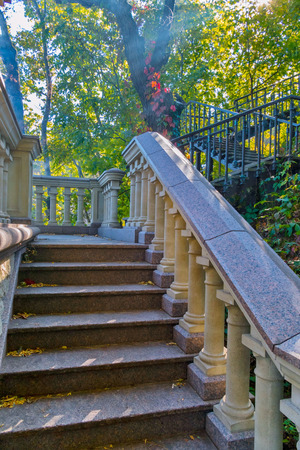A multi-level ladder with beautiful railings in the form of columns leading upの写真素材