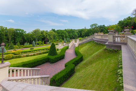 A chaotic walking staircase in the park with a green, cropped lawnの写真素材