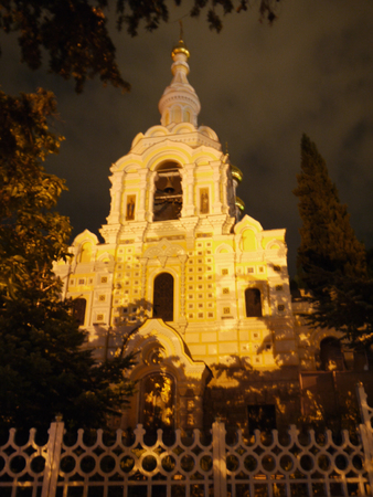 The white church is flooded with bright sun rays from one side and gloomy sky from the other side. Wonders of natureの写真素材