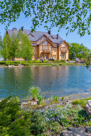 Luxurious house on the shore of a clean lake with birches around. Live in such a continuous giftの写真素材