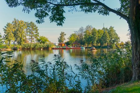 a large lake with a small porch in the middle and wooden gazebos on the shore. Novi Petrivtsi, Ukraineの写真素材