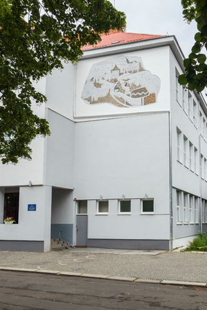 Entrance to a three-story building with white-gray walls and a red roofのeditorial素材