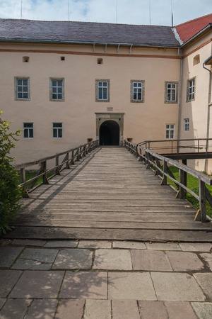 Wooden bridge with railing to the arch of the entrance to the castle. Transcarpathia Uzhhorod Ukraineのeditorial素材