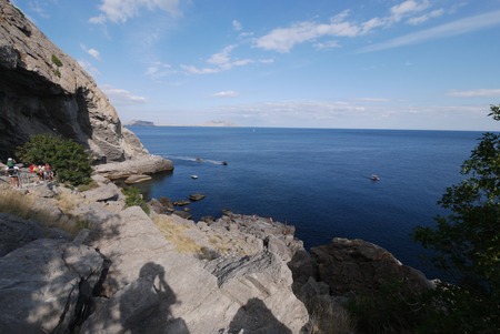An observation deck in a cave in a rock on the shores of the blue sea, with a magnificent landscapeの写真素材