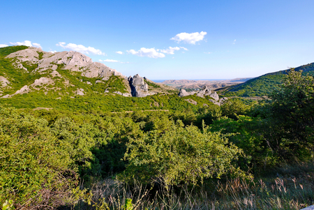 A magnificent panorama stretching into the distance to the horizon line of mountains under the blue skyの写真素材