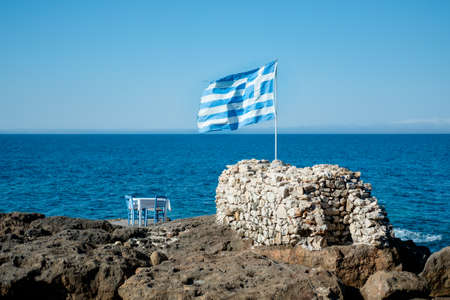 Single lonely restaurant table on a small island in Greece south mediterranean Europeの写真素材