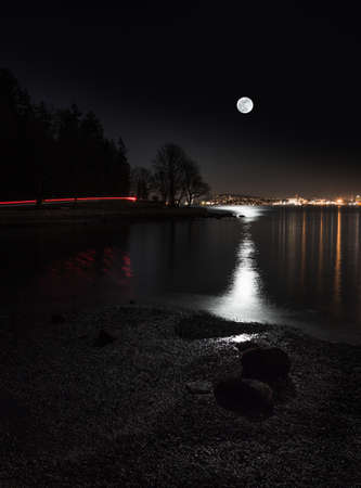 Moon rising over the city viewed from Vancouvers Stanley Park.