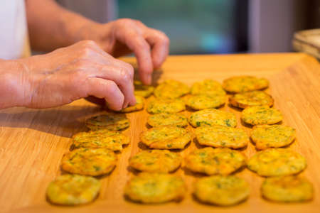 Close-up of a womans hands making fritters.の写真素材