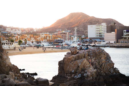CABO SAN LUCAS, BCS, MEXICO - FEB 02, 2017: Group of youth spending the late afternoon by the public beach near the marina in Cabo San Lucas.のeditorial素材