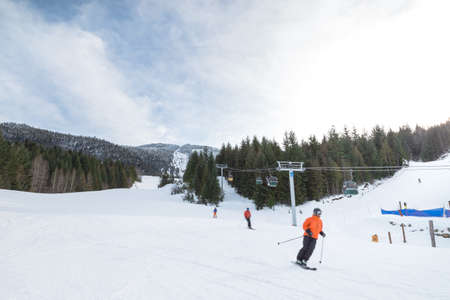 Blurred skiers going downhill on Whistler Mountain.の写真素材