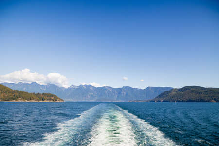 A view of the Sunshine Coast as seen from the deck of a ferry.の写真素材