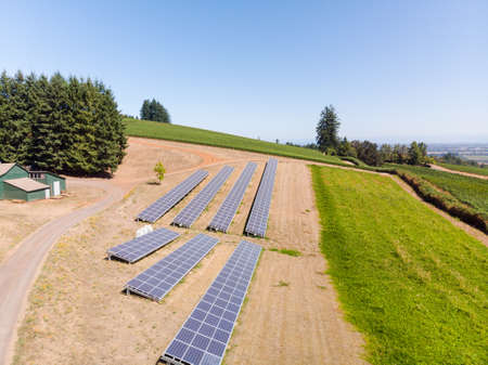 Aerial view of a solar panel array in rural Oregon overlooking a valley.