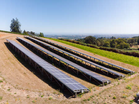 Aerial view of a solar panel array in rural Oregon overlooking a valley.