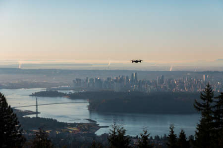 A small consumer drone overlooking the city of Vancouver