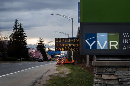 RICHMOND, BC, CANADA - MAR 29, 2020: An electronic road sign at YVR airport displaying public health...