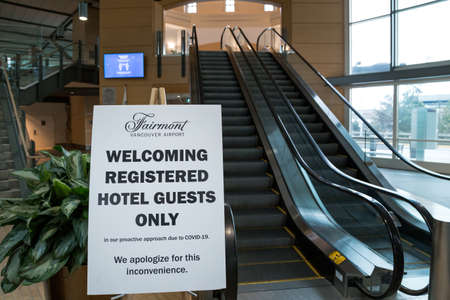 RICHMOND, BC, CANADA - MAR 29, 2020: A public health notice sign at YVR in light of the COVID-19 coronavirus pandemic.のeditorial素材