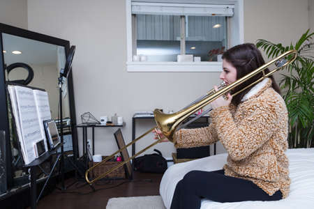 NORTH VANCOUVER, BC, CANADA - APR 16, 2020: A young woman adapting to self isolation during the Covid 19 pandemic by teaching students from homeのeditorial素材