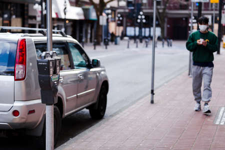 DOWNTOWN VANCOUVER, BC, CANADA - APR 01, 2020: Street parking bylaws are no longer being enforced...