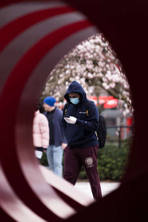 DOWNTOWN VANCOUVER, BC, CANADA - APR 01, 2020: Pedestrian in downtown Vancouver wearing a medical...