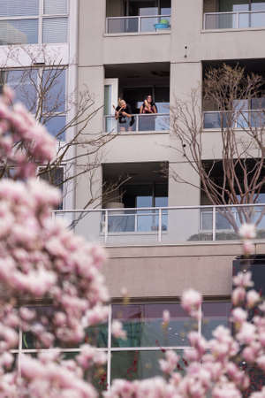 DOWNTOWN VANCOUVER, BC, CANADA - APR 01, 2020: Roomates that are self quarantining coming out on...