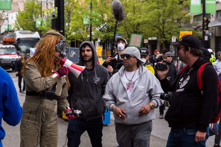 DOWNTOWN VANCOUVER, BC, CANADA - APR 26, 2020: An antifa member disrupts an anti lockdown protest...