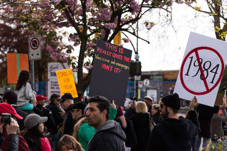 DOWNTOWN VANCOUVER, BC, CANADA - APR 26, 2020: Anti lockdown protesters march in defiance of the...