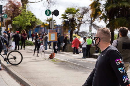 DOWNTOWN VANCOUVER, BC, CANADA - APR 26, 2020: Anti lockdown protesters march in defiance of the...
