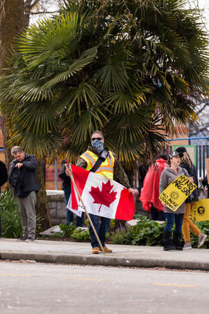 DOWNTOWN VANCOUVER, BC, CANADA - APR 26, 2020: Anti lockdown protesters march in defiance of the...