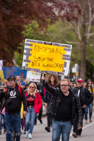 DOWNTOWN VANCOUVER, BC, CANADA - APR 26, 2020: Anti lockdown protesters march in defiance of the...