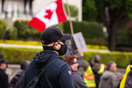 DOWNTOWN VANCOUVER, BC, CANADA - APR 26, 2020: Anti lockdown protesters march in defiance of the government imposed quarantine measures taken to slow the spread of the Covid 19 virus.のeditorial素材