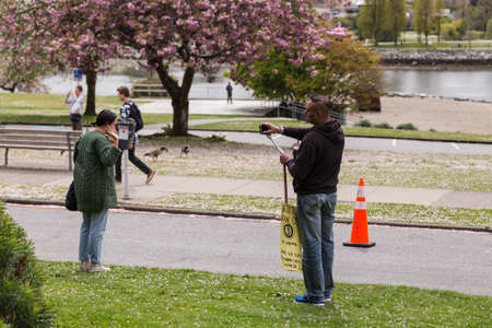 DOWNTOWN VANCOUVER, BC, CANADA - APR 26, 2020: Anti lockdown protesters march in defiance of the government imposed quarantine measures taken to slow the spread of the Covid 19 virus.のeditorial素材