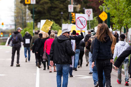 DOWNTOWN VANCOUVER, BC, CANADA - APR 26, 2020: Anti lockdown protesters march in defiance of the government imposed quarantine measures taken to slow the spread of the Covid 19 virus.のeditorial素材