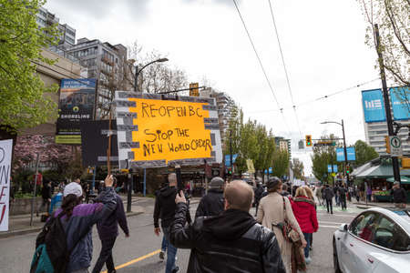 DOWNTOWN VANCOUVER, BC, CANADA - APR 26, 2020: Anti lockdown protesters march in defiance of the government imposed quarantine measures taken to slow the spread of the Covid 19 virus.のeditorial素材
