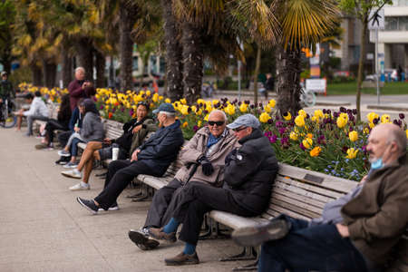 DOWNTOWN VANCOUVER, BC, CANADA - APR 26, 2020: Vancouver residents enjoying the park at English Bay...