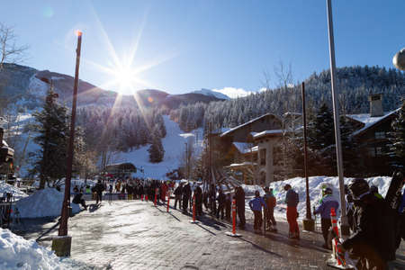 WHISTLER, BC, CANADA - FEB 18, 2021: Large ski lift line up of skiiers due to Covid 19 restrictions...