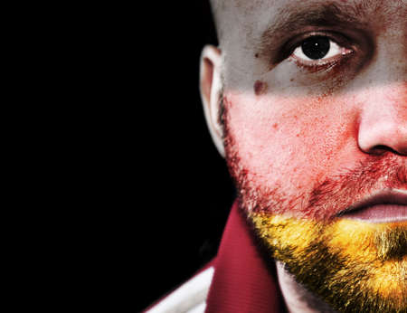  fan with flag of Germany painted on his faceの写真素材