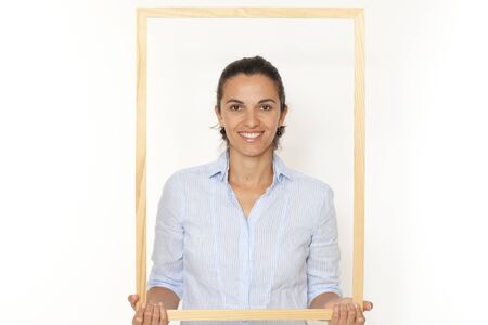 Pretty woman with a frame smiling