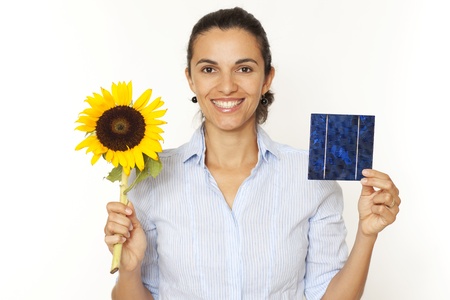Pretty woman shows a solar cell and a sunflowerの写真素材